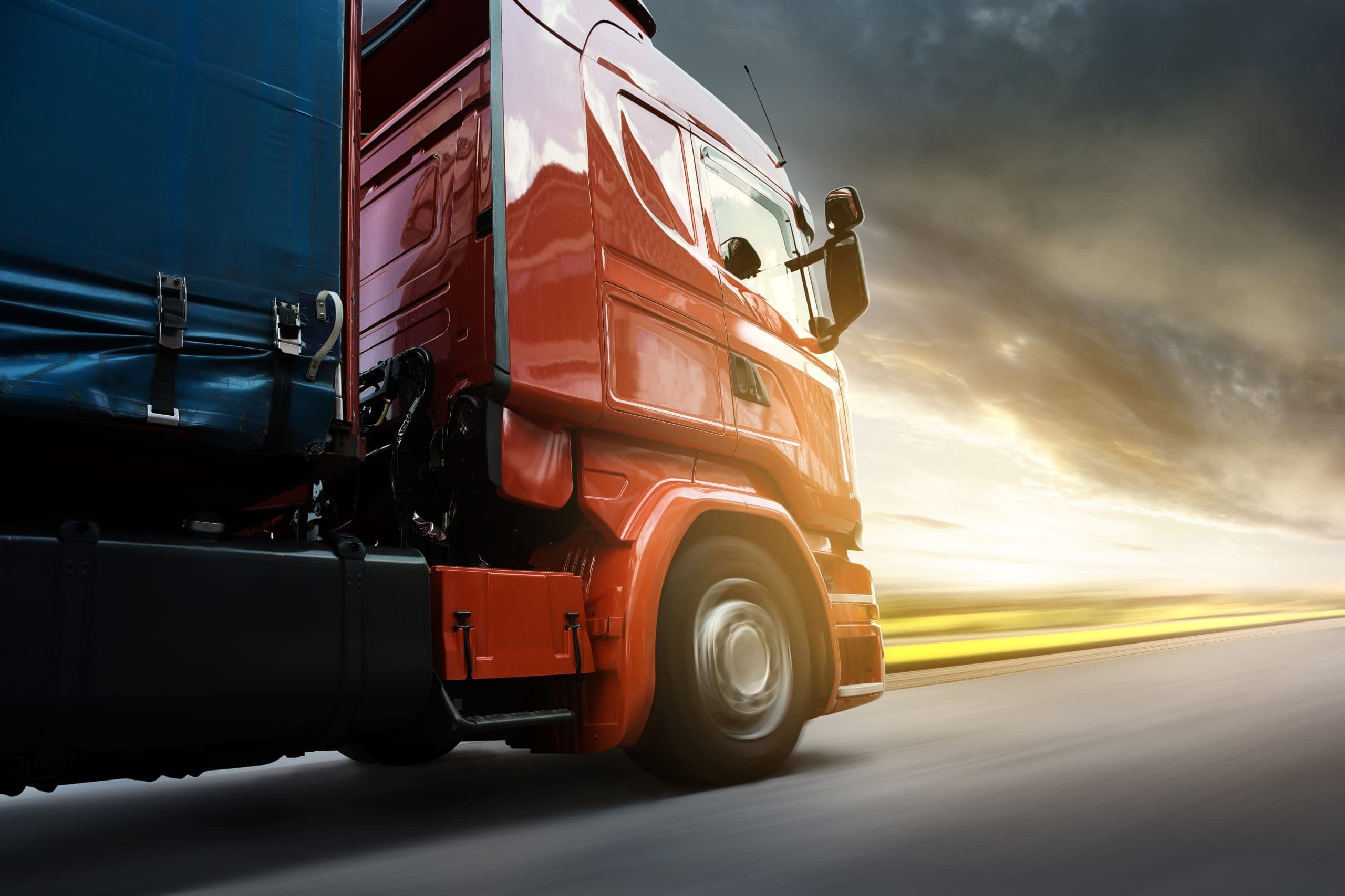 Truck on road at sunset