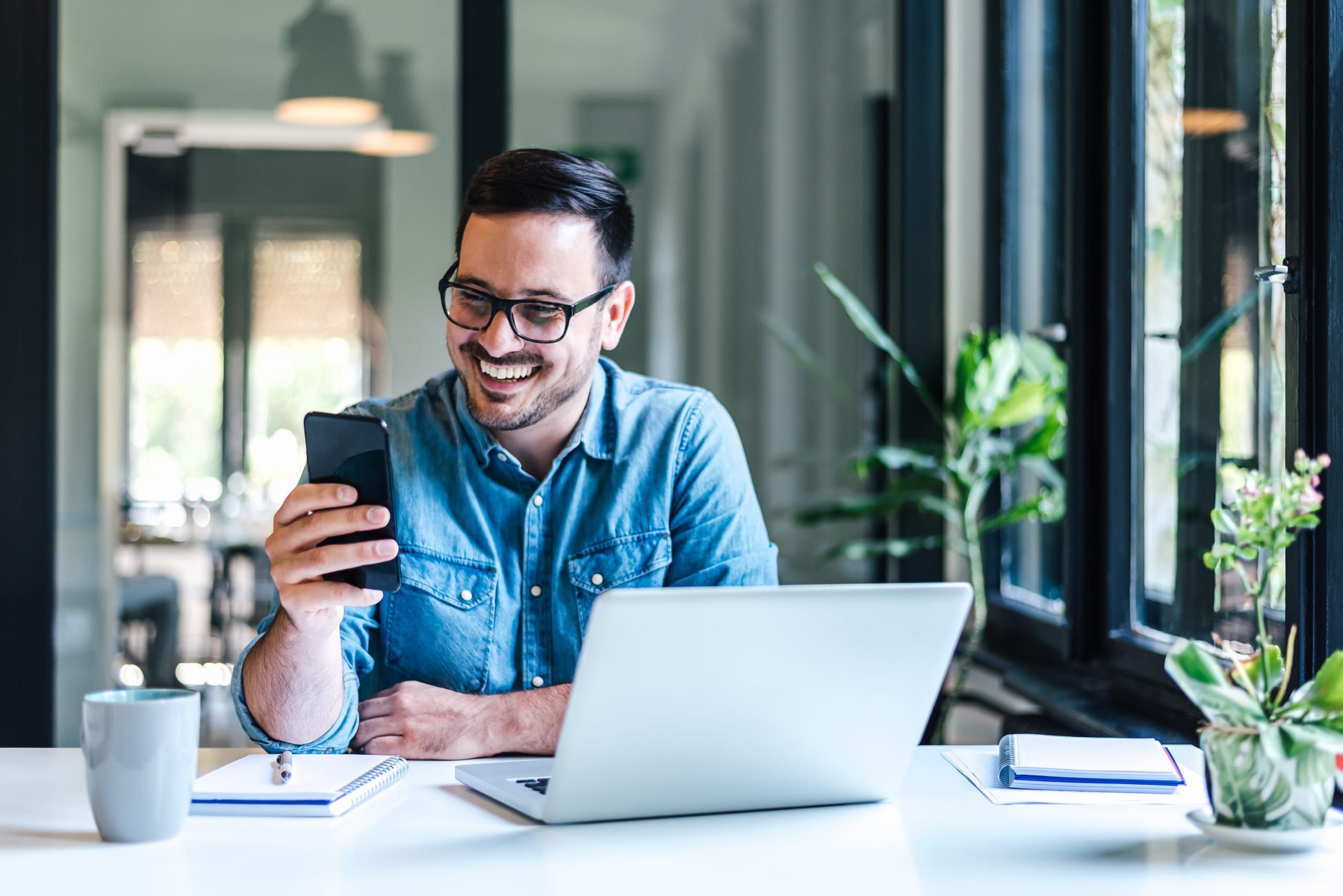 Man on laptop and phone