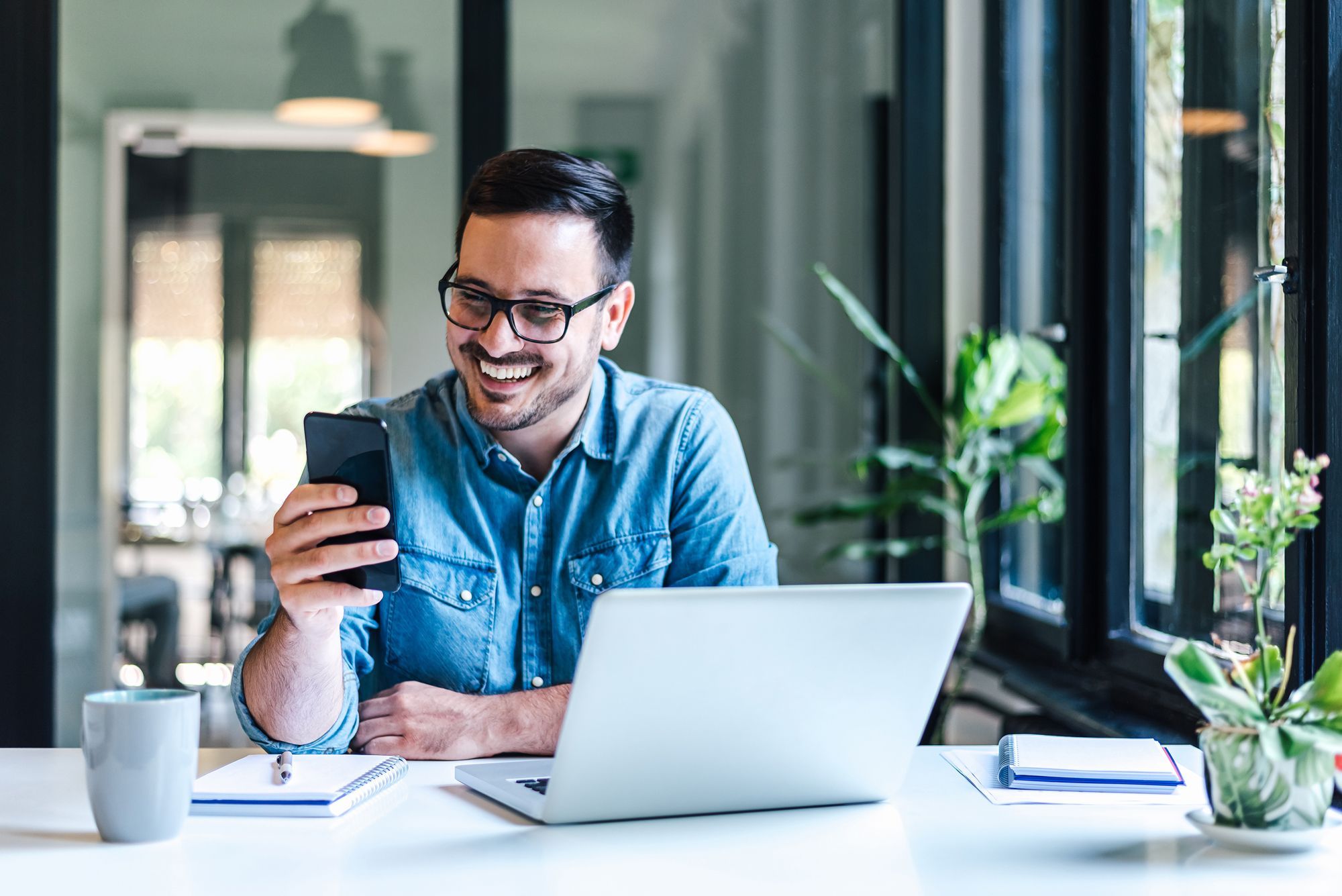 Man on laptop and phone